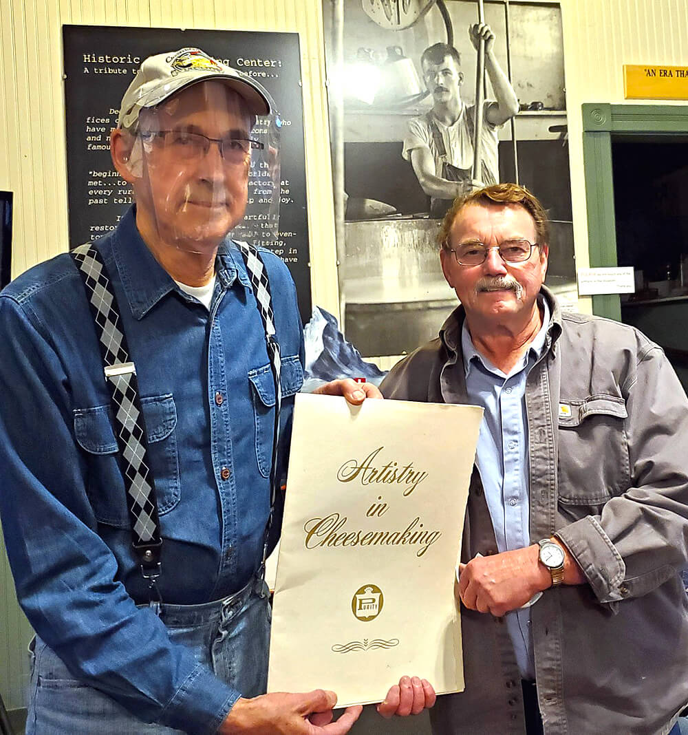 Past president, Dave Buholzer, (right) shown presenting NHCC Archives chairman, Fritz Kopp,